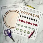A photograph of the printable pizza craft templates on a marble background.