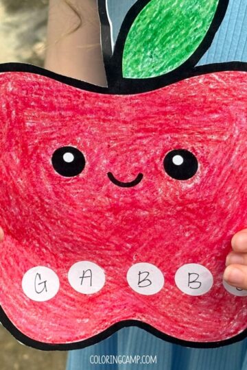 A child holding the back to school name craft.