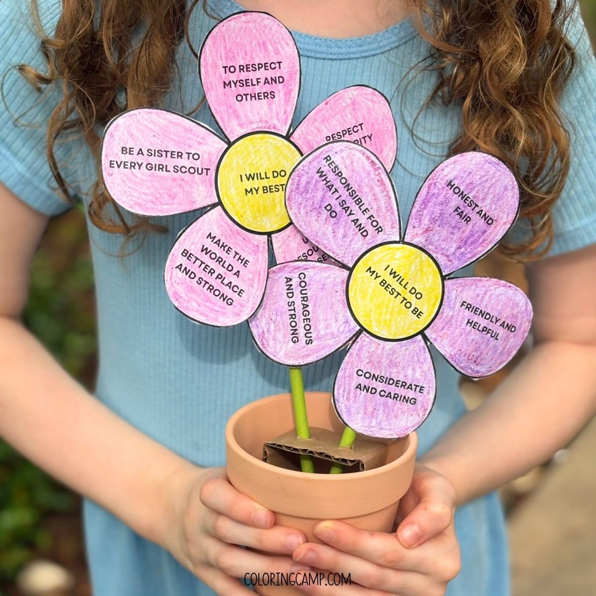 The Girl Scout Law Craft being held by a girl.