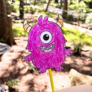 Halloween wand craft being held by a child's hand.