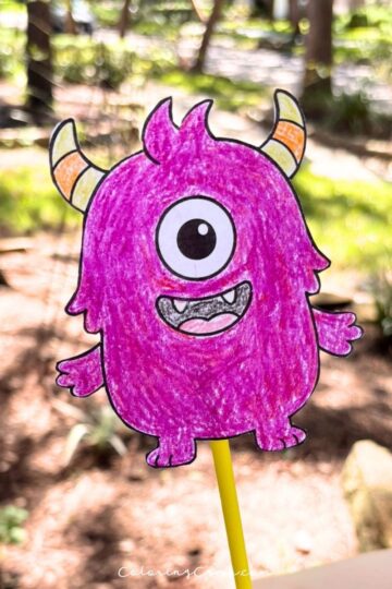 Halloween wand craft being held by a child's hand.