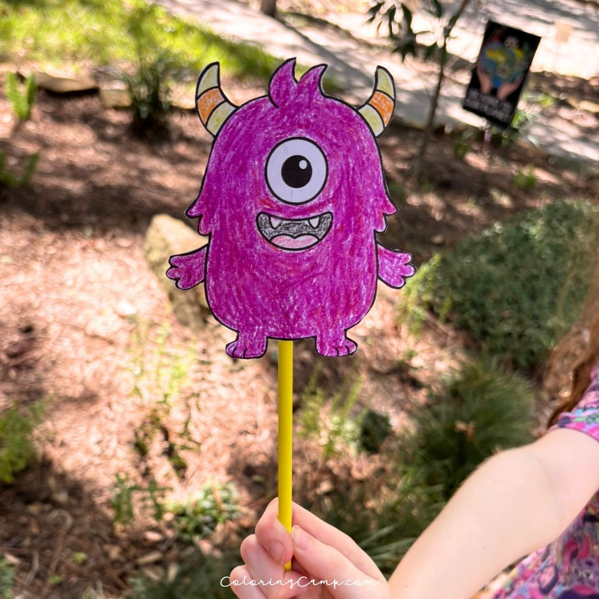 Halloween wand craft being held by a child's hand.