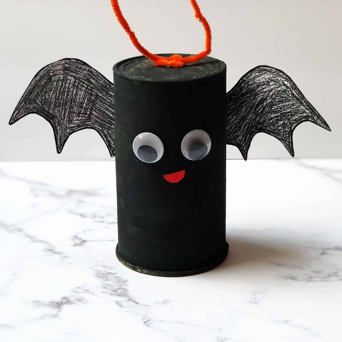 Halloween bat craft from upcycled oatmeal container.