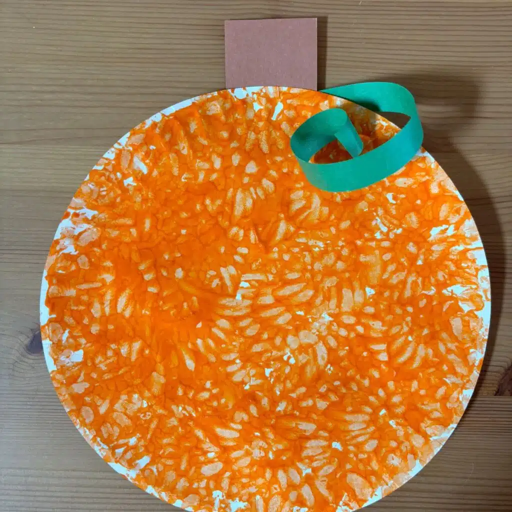 Pumpkin painted paper plate craft.
