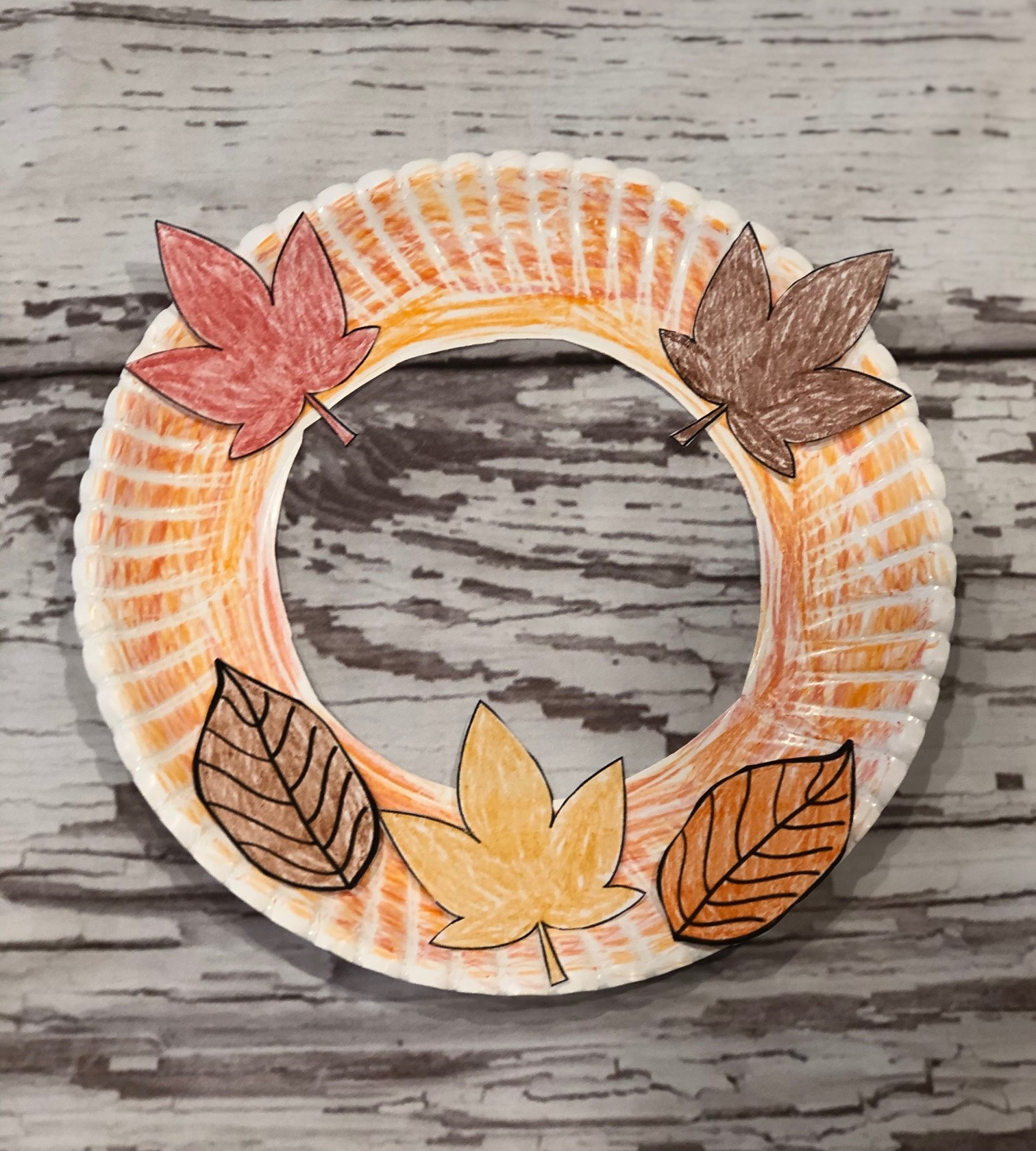 fall paper plate wreath with leaves.