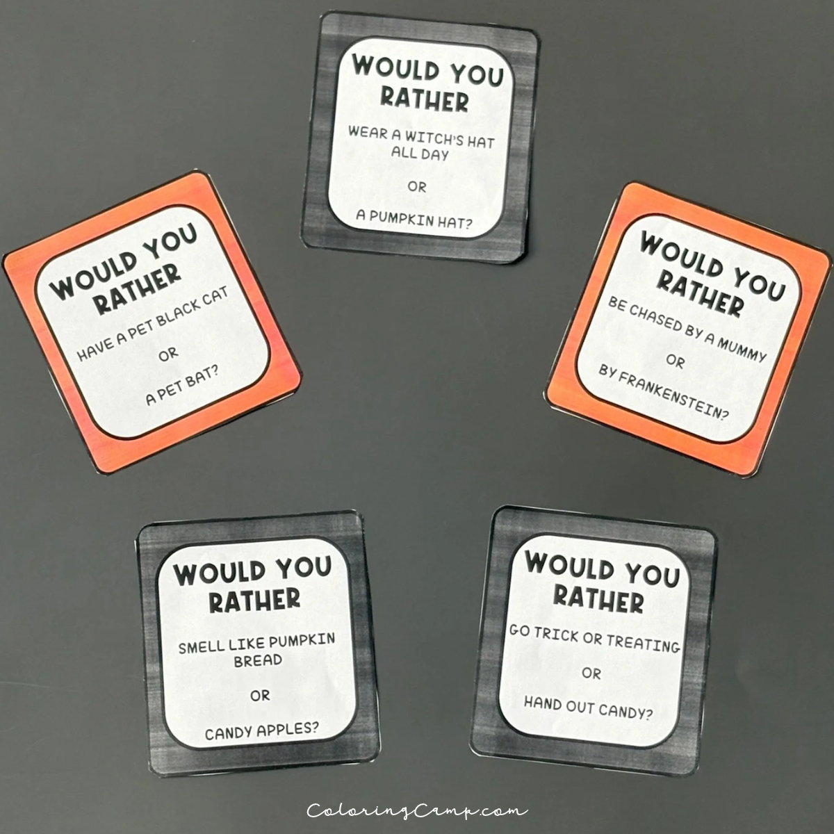 Halloween would you rather question cards on a black background.